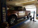 Professional vehicle lifting equipment at Mill Run Collision Service, located at Mill Village, PA, 16427, allows our damage estimators a clear view of all collision related damages.